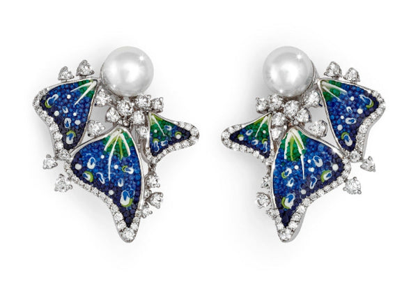 Butterfly-shaped earrings with blue and green details and pearl centers on a white background