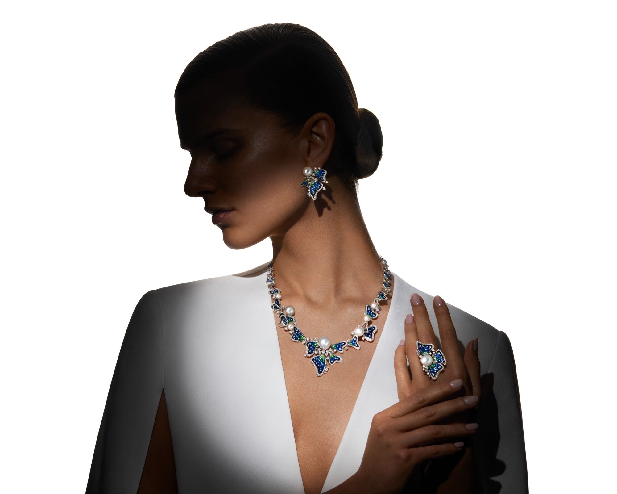 Woman wearing a necklace and earrings with a white background