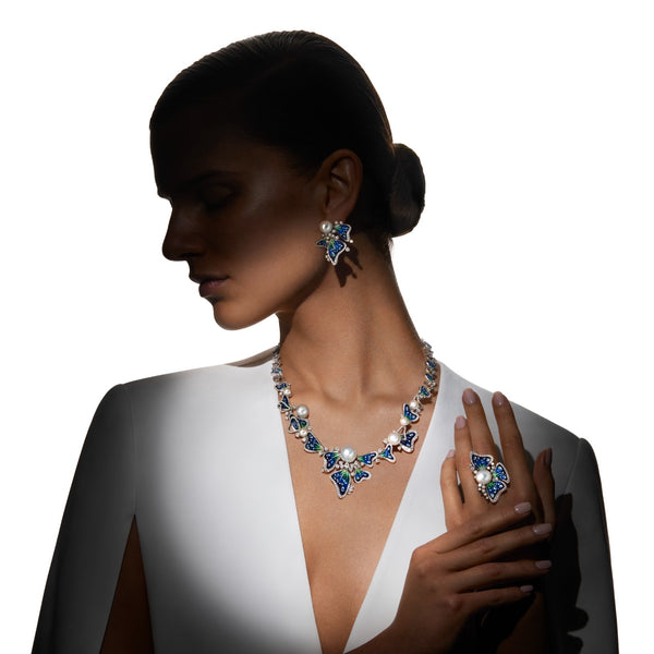 Woman wearing a necklace and earrings with a white background