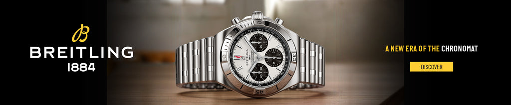 Breitling watch on a wooden surface with brand logo and text.