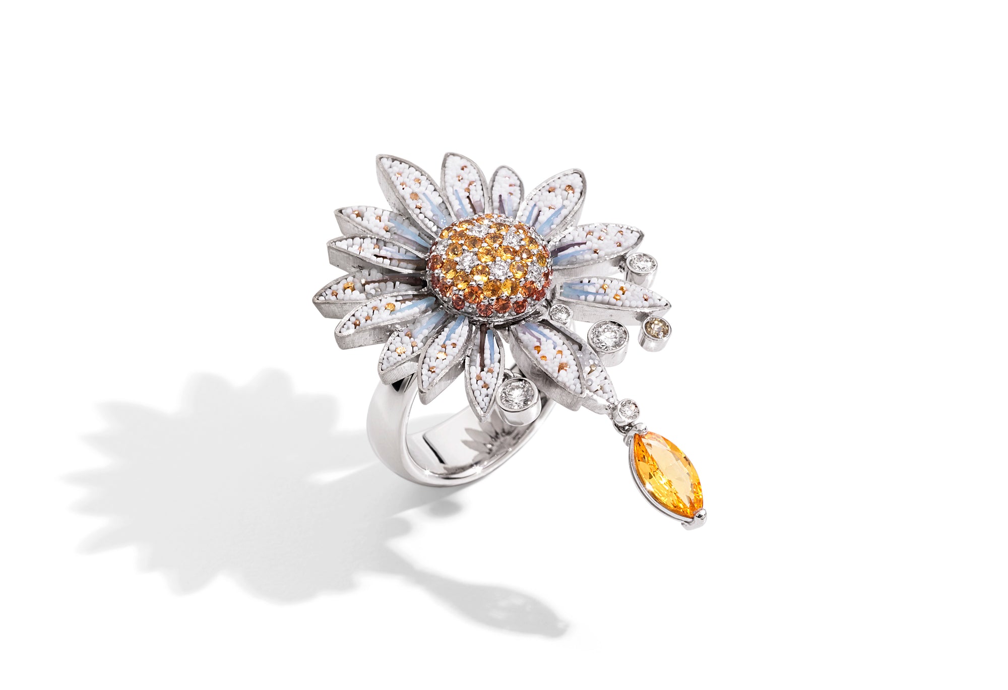 Daisy-shaped ring with gemstones on a white background