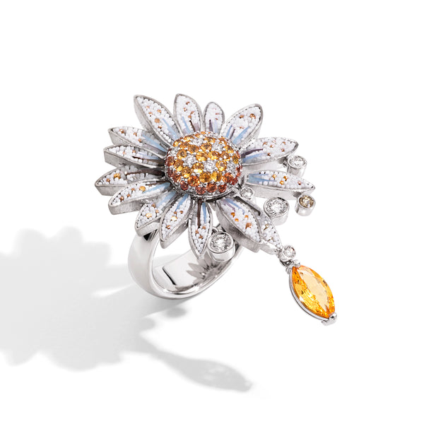 Daisy-shaped ring with gemstones on a white background