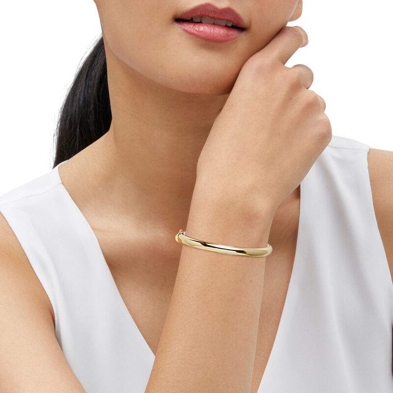 14K yellow gold 6.2mm high-polished oval round tube hinge bangle bracelet