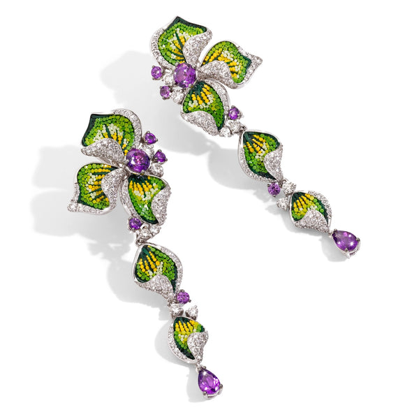 Pair of earrings with green leaf-like design and purple gemstones on a white background