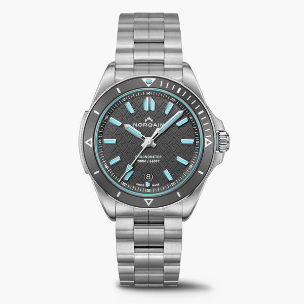 Silver watch with a black face on a white background