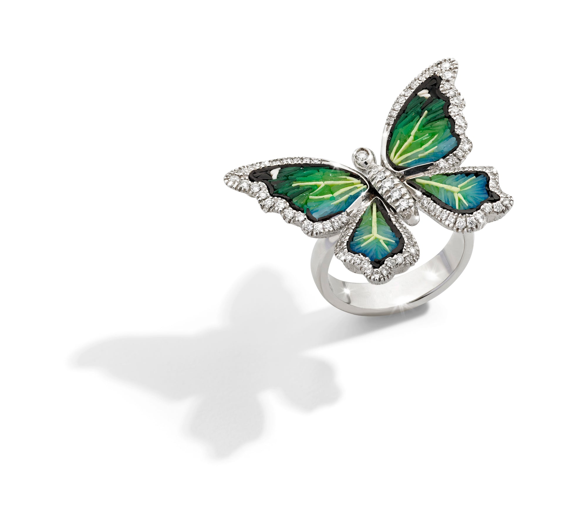 Butterfly-shaped ring with green and yellow design on a white background