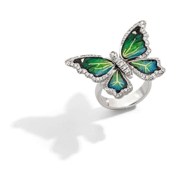 Butterfly-shaped ring with green and yellow design on a white background