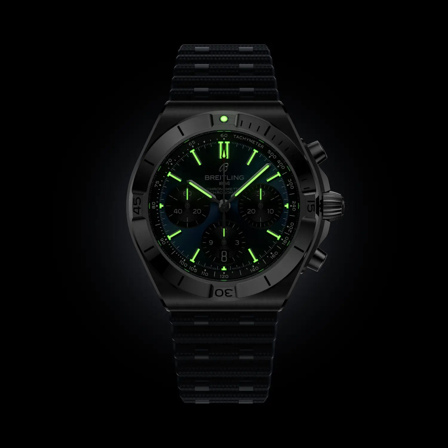 Breitling watch with green glowing face on a black background