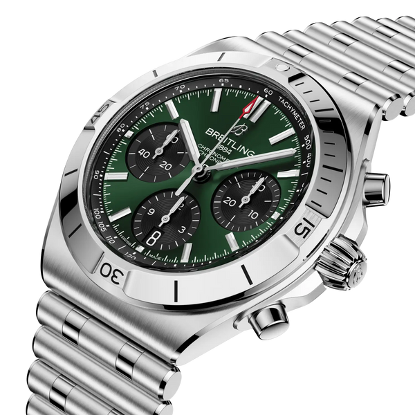 Silver Breitling watch with a green dial on a white background