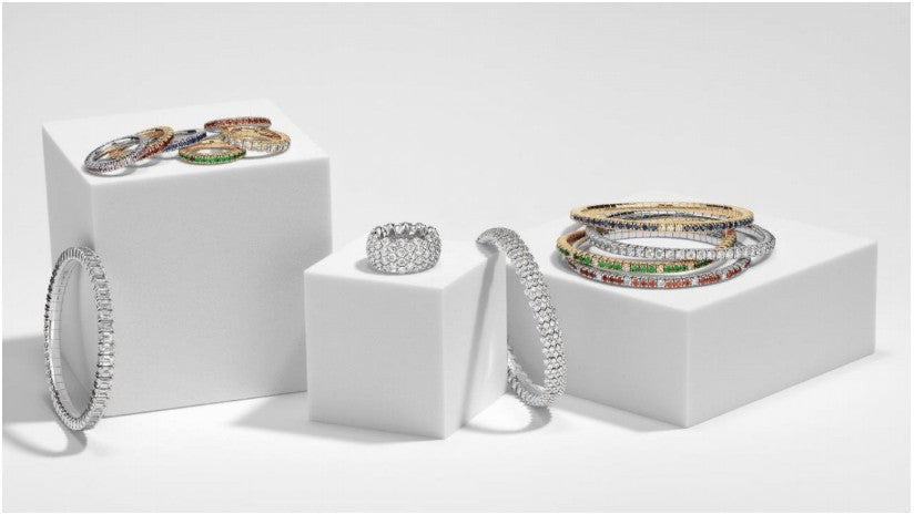Product View- Several rings and bracelet displayed on white blocks. Jewelry is from David Weisz's Stretch Collection