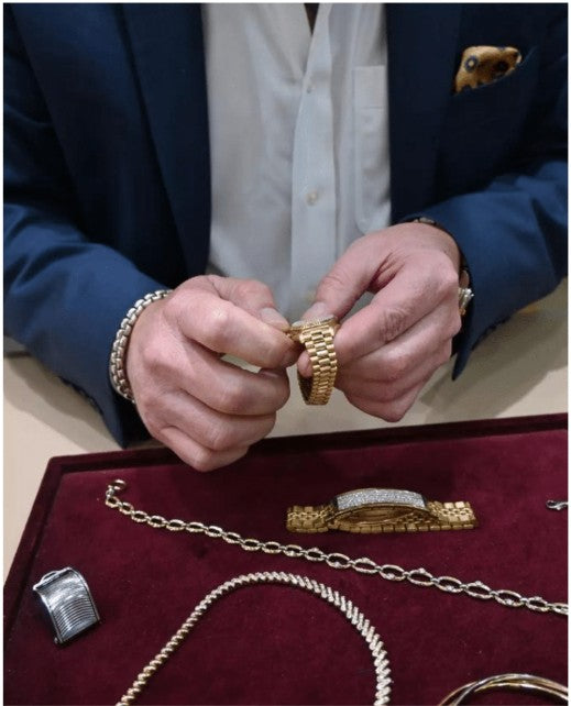Mans hands holding gold watch