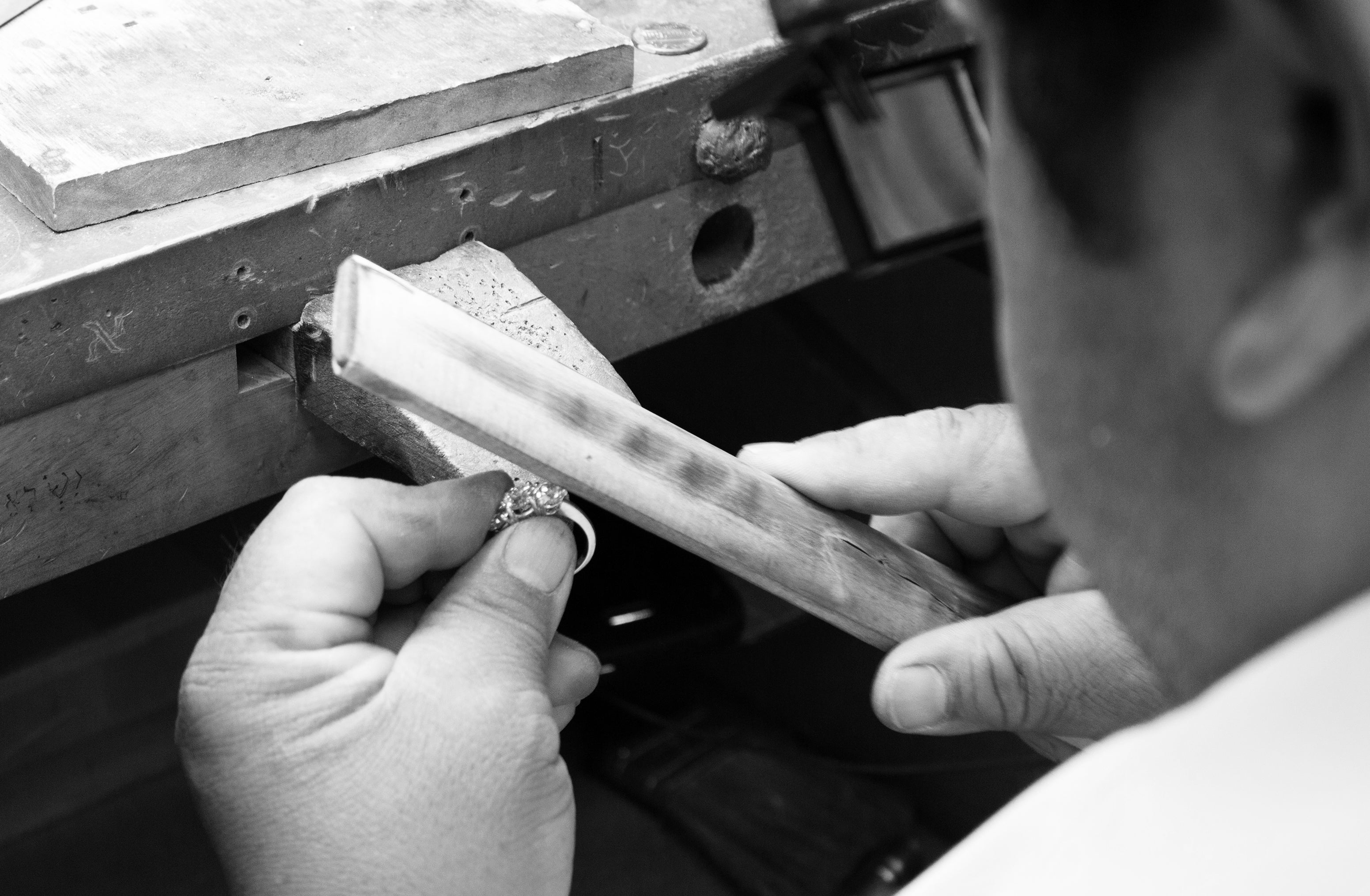 Man using tools to custom make jewelry