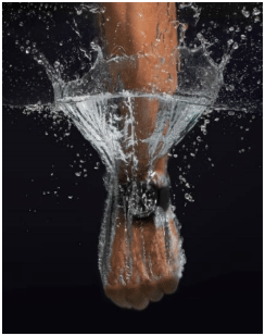 Lifestyle Image- Men's arm making a splash into water with diver watch