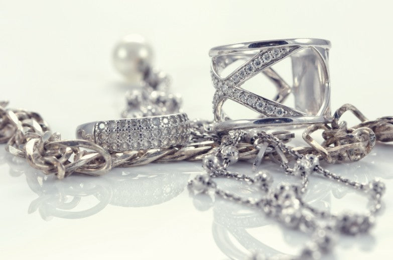 Cluster of silver jewelry including necklace, bracelet, and rings