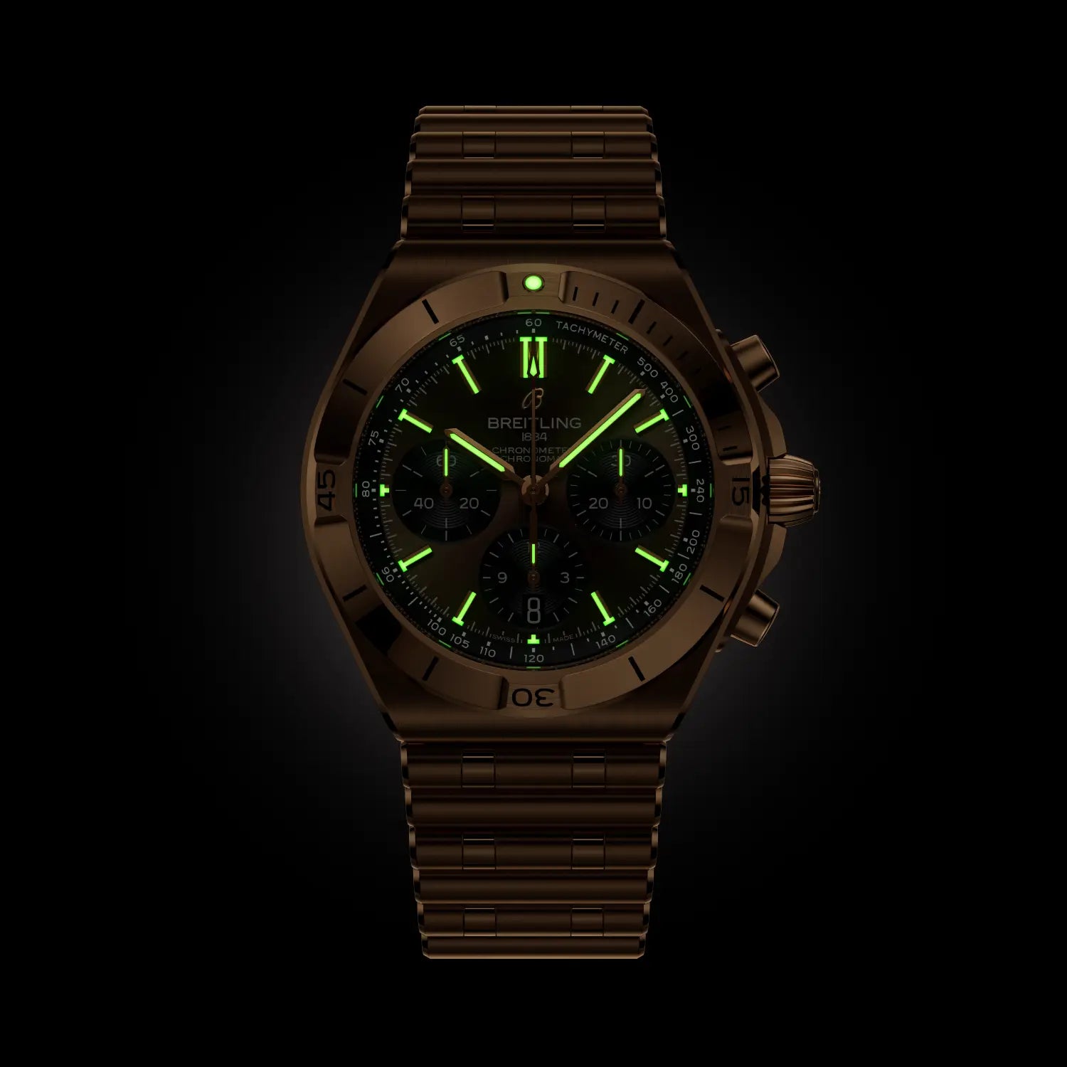18k Red gold watch with green glowing face on a black background