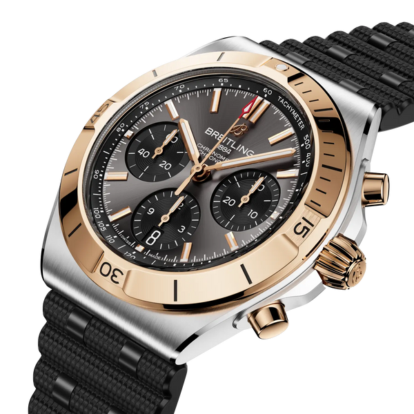 Luxury watch with black strap and gold accents on a white background